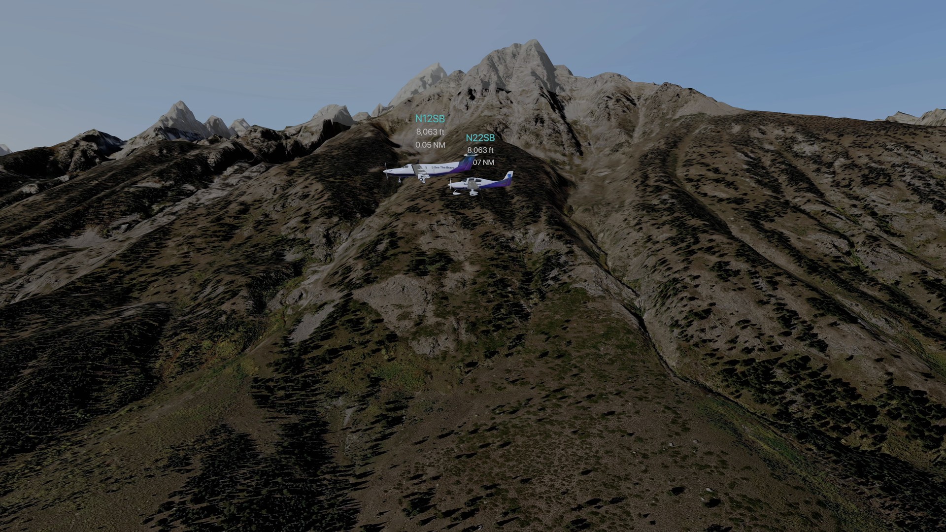 Two small aircraft with their data tags flying past the Grand Teton wall